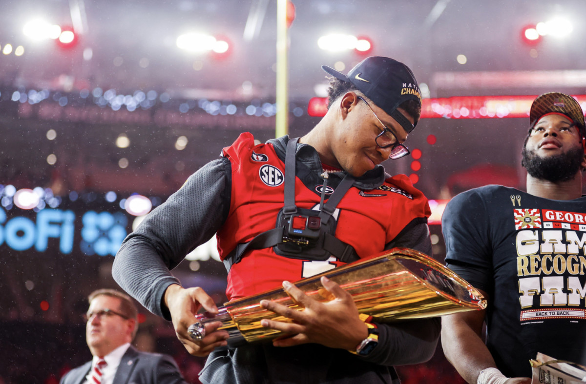 Nolan Smith with the 2023 national championship trophy after the Georgia Bulldogs defeated TCU by a score of 65-7